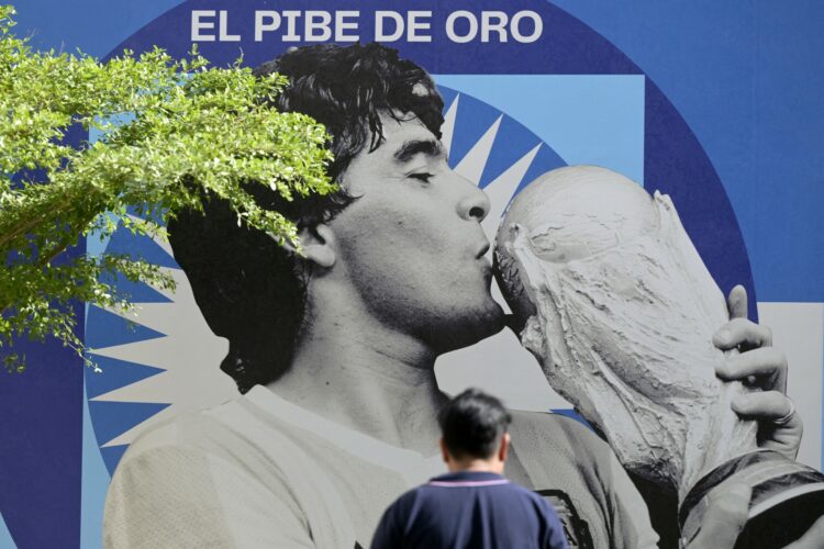 (FILES) An image of late football star Diego Maradona is seen on the 2nd anniversary of his death at CONMEBOL fan zone "Tree of dreams" during the Qatar 2022 World Cup football tournament in Doha, on November 25, 2022. Four years after the death of Argentine football legend Diego Maradona, seven healthcare professionals will go on trial on March 11, 2025, in San Isidro, Buenos Aires, accused of negligence that may have led to his death. Over a hundred witnesses, including members of Maradona's family and doctors who tended to him down the years, will take the stand over the course of the four-month trial. (Photo by JUAN MABROMATA / AFP)
