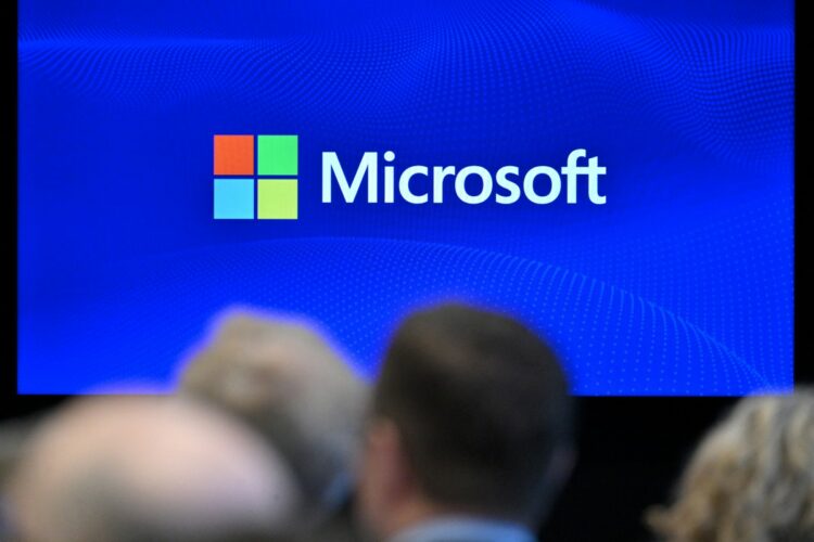 The Microsoft logo is displayed on a screen during a speech by Microsoft vice-chair and president "digital resilience in a time of geopolitical volatility" at the Atlantic Council, in Brussels on April 30, 2025. (Photo by Nicolas TUCAT / AFP)