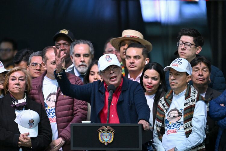 Colombia's President Gustavo Petro gives a speech to his supporters, accompanied by members of his cabinet, in Bogota on February 19, 2026, during a demonstration to back the vital minimum wage decree, which was provisionally suspended by the Council of State. (Photo by Raul ARBOLEDA / AFP)