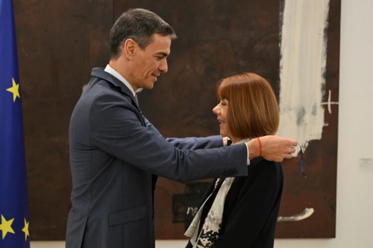 In this handout image released by La Moncloa on March 3, 2026 Spanish Prime Minister Pedro Sanchez (L) delivers the Order of Civil Merit to French woman Gisele Pelicot, a figure in the fight against sexual violence, at La Moncloa Palace in Madrid. Gisele Pelicot published her memoirs, in which she tells for the first time the rapes organised by her ex-husband and the historic trial in Avignon, which made her a leading figure in the fight against sexual violence. (Photo by Borja Puig de la BELLACASA / LA MONCLOA / AFP) / RESTRICTED TO EDITORIAL USE - MANDATORY CREDIT "AFP PHOTO / LA MONCLOA" - NO MARKETING NO ADVERTISING CAMPAIGNS - DISTRIBUTED AS A SERVICE TO CLIENTS